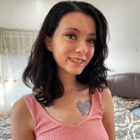Amateur dark haired girl Corra Cox strips exposing her hairy pussy