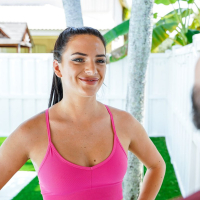 Dark haired Alice Visby taking hardcore pilates class with her trainer
