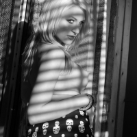 Blonde hottie Katie Summers flashing her tits behind the window