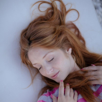 Horny teen redhead Red Fox strips on a lounge chair