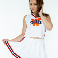 Lovely cheerleader Dani Daniels gets naked and poses in black high heels