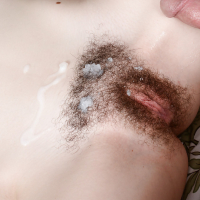 Amateur lady Emma Evins gets a big cumshot blown on hairy vagina