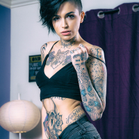 Leigh Raven exposes her inked body in the living room