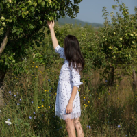 Skinny Adel Morel poses naked in an apple garden
