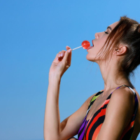 Slim babe Alice Wonder licking a cherry lollipop
