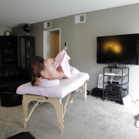 Latina Gigi Rivera stripping off shorts before getting naked on massage table