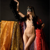 Sweet Lilya wearing a Mask showing her small Boobs