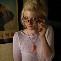 Casey Deluxe wears a white Shirt while Posing sexy