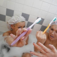 Young dykes Kasey Jordan and Ally Kay in bathtub with suction dildo
