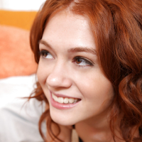 Curlyhaired teen Alice Green is playing with her juicy ass