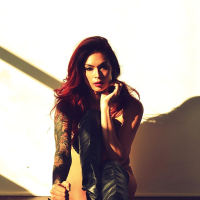 Tattooed MILF Tera Patrick displays perfect big tits while posing in boots