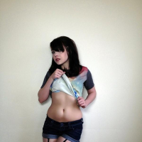 Pretty alt model Lilly Rose gives you a striptease next to the wall