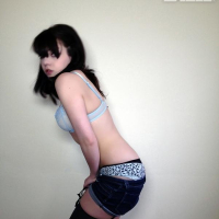 Pretty alt model Lilly Rose gives you a striptease next to the wall