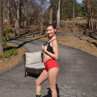 Shameless young babe Emma Sirus toys her twat and squirts in the driveway