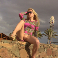 Naughty Tinkerbell gives her studded pussy plenty of hot sun posing on holiday