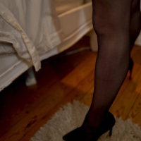 Gorgeous Tommy Hill has fun stripping and teasing in lingerie and stockings