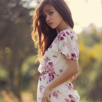 Kit Rysha sits in a Field with her tiny Boobs out