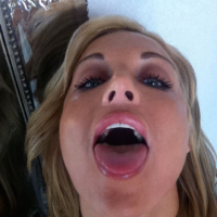 Kayden Kross playing with her phone camera at home