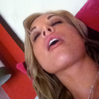 Kayden Kross playing with her phone camera at home