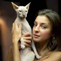 Melena Maria Rya showing her cat while posing in black lingerie