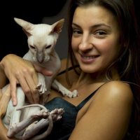 Melena Maria Rya showing her cat while posing in black lingerie
