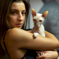 Melena Maria Rya showing her cat while posing in black lingerie
