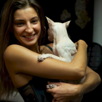 Melena Maria Rya showing her cat while posing in black lingerie