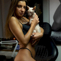 Melena Maria Rya showing her cat while posing in black lingerie