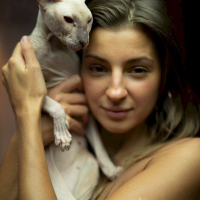 Melena Maria Rya showing her cat while posing in black lingerie