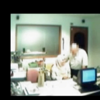 Veiled Arab secretary blowing white manager