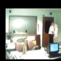 Veiled Arab secretary blowing white manager