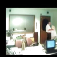 Veiled Arab secretary blowing white manager