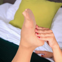 Katerina Hartlova rubs her feet with baby oil