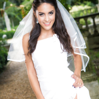 Newly married bride Carolina Abril posing outdoors in wedding dress