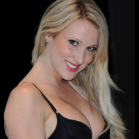 Busty Rebecca Ferdinando wearing a low cut black dress at the Total Recall UK