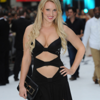 Busty Rebecca Ferdinando wearing a low cut black dress at the Total Recall UK