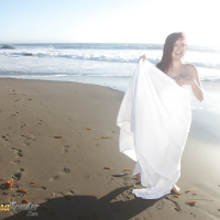 Buxom pornstar Tessa Fowler modeling topless outdoors on beach
