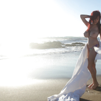 Buxom pornstar Tessa Fowler modeling topless outdoors on beach