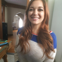 Buxom pornstar Tessa Fowler posing in pleated skirt while flashing big tits