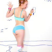 Redhead teen Dolly Little has some naked fun