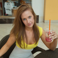 Hot coed April Brookes gives you some peeks up her skirt at a public mall