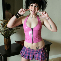 Andi posing in pink skirt and top