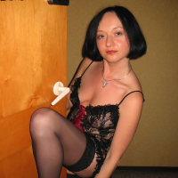 Mayas Handjobs poses wearing nylons and negligee