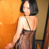 Mayas Handjobs poses wearing nylons and negligee