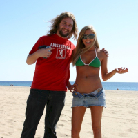 Juicy blonde Brynn Tyler posing in a green bikini on the beach