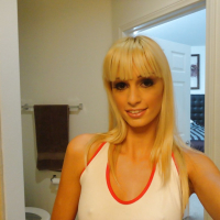 Blond chick Erica Fontes taking selfies in mirror while taking off her clothes