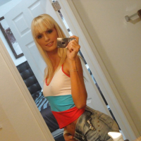 Blond chick Erica Fontes taking selfies in mirror while taking off her clothes