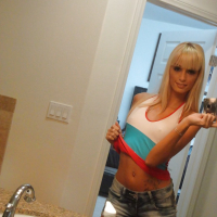 Blond chick Erica Fontes taking selfies in mirror while taking off her clothes