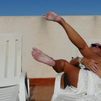 Good looking babe Natalie K sunbathing and rubbing her cunt