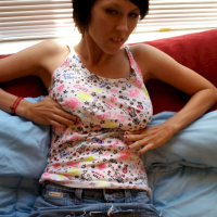 Good looking girl lifts her skirt to show her red panties